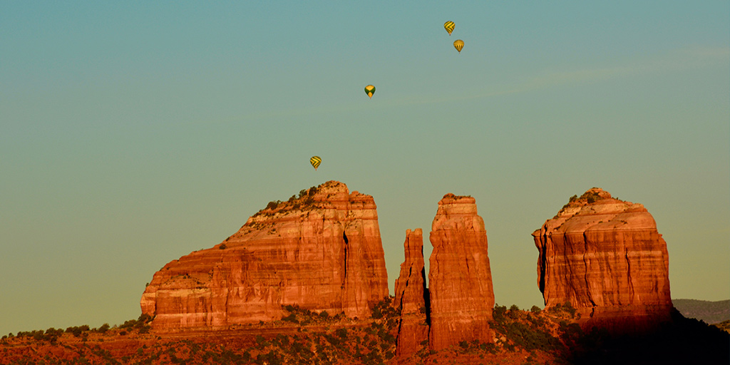 hot air balloons over Sedona red rock landscape