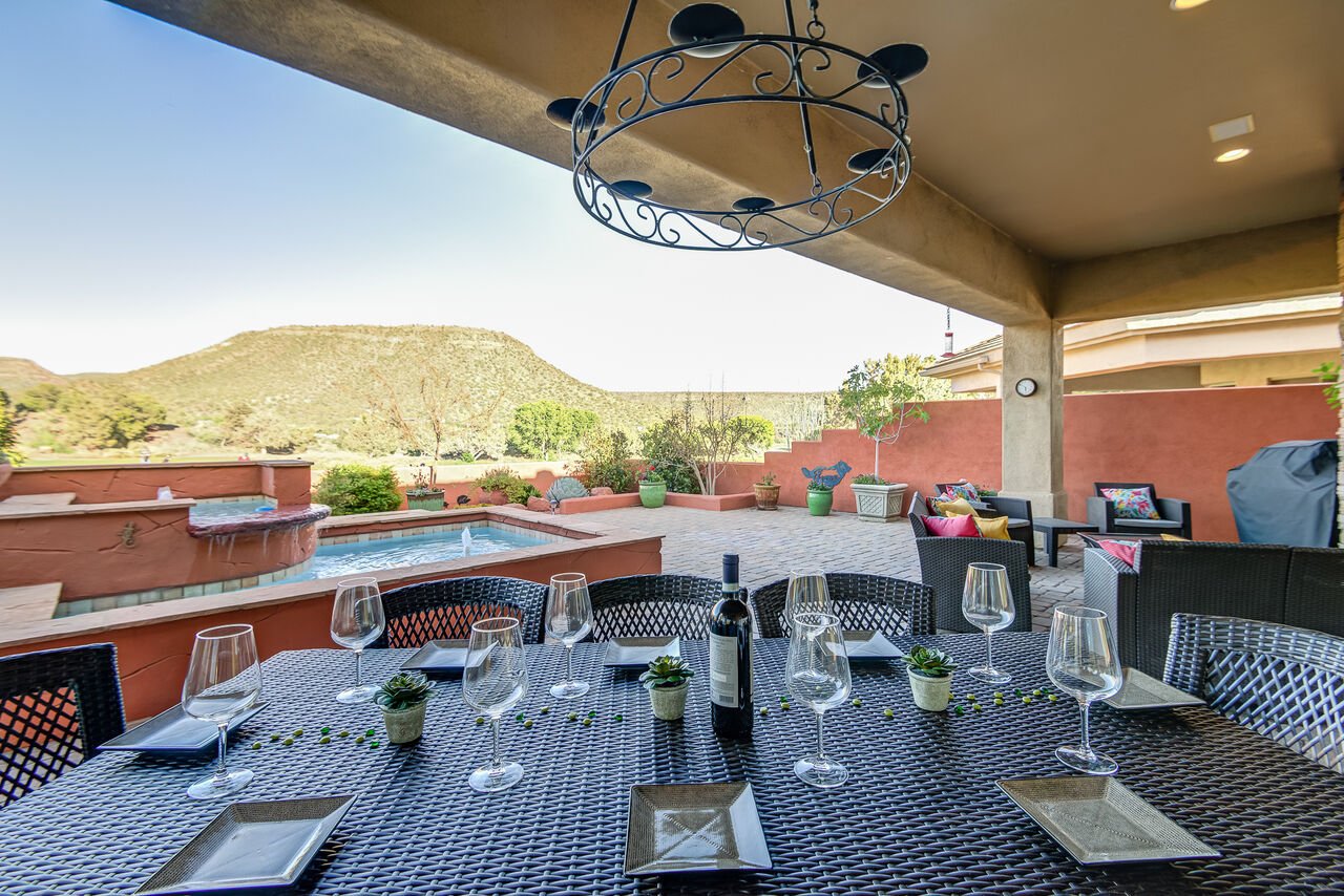 The large back patio and hot tub of a Sedona Weekly Rental